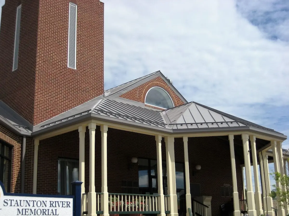 Skilled roofing craftsmen working on a residential roof in Delmont
